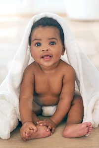 african american baby smiling in a blinket