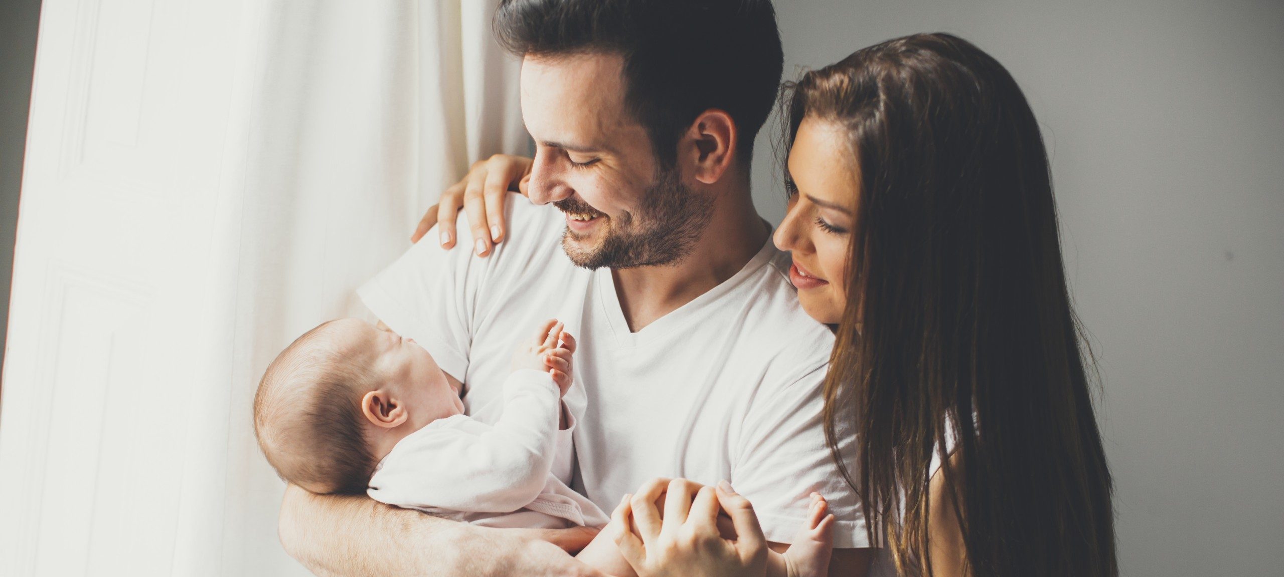 new parents holding their new born baby